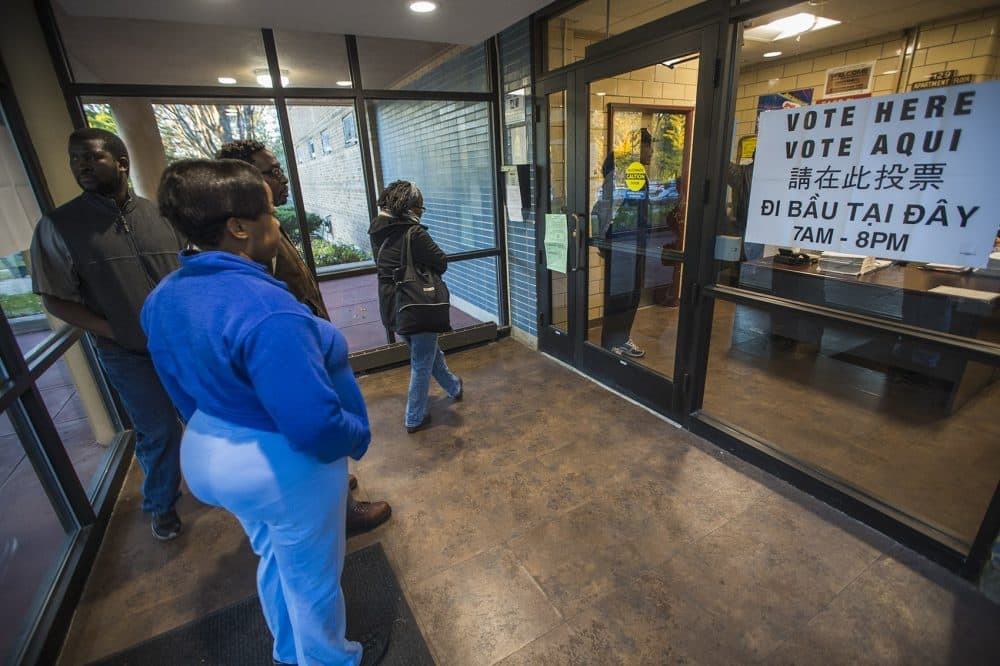 Voters line up outside of the Holgate Apartments before the polls open at 7 a.m. (Jesse Costa/WBUR)