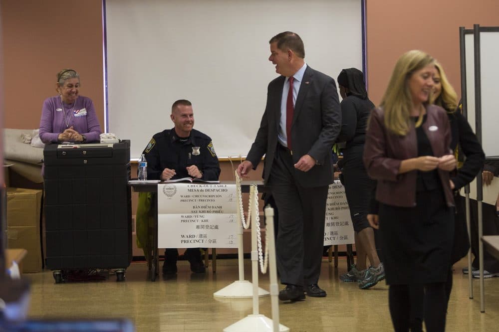 Boston Mayor Marty Walsh has a laugh with election officials at the Lower Mills Branch of the Boston Public Library. (Jesse Costa/WBUR)