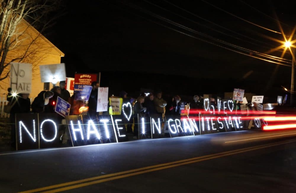 Protesters hold signs ahead of an event featuring Steve Bannon, the former chief strategist to President Donald Trump, in Manchester, N.H., Thursday, Nov. 9, 2017. (Mary Schwalm/AP)