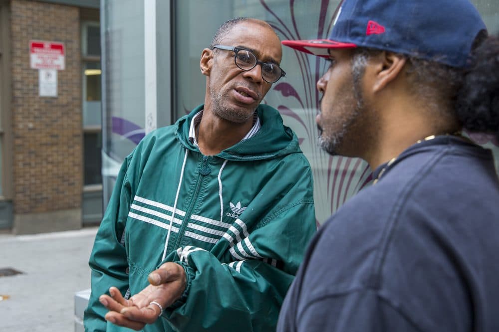Higginbottom talks with Marino Rosario Jr. outside St. Francis House. (Robin Lubbock/WBUR)