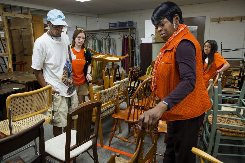 Higginbottom and Retha Watson, a housing placement specialist from Pine Street Inn, pick out items for his apartment at a warehouse in Acton run by the nonprofit Household Goods. (Robin Lubbock/WBUR)
