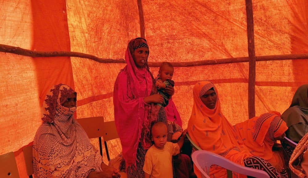On Sept. 3, Ethiopian women wait in a tent to receive food aid due to drought conditions in the Danan district of the Somali region of Ethiopia, which hasn't seen significant amounts of rain in the past three years. (Elias Meseret/AP)