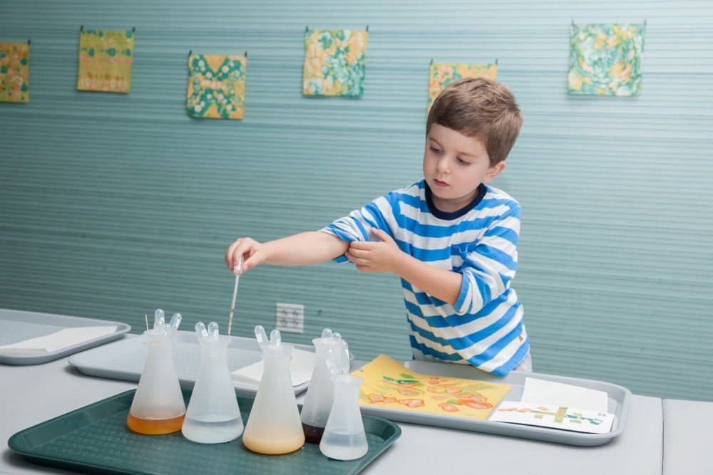 A museum visitor experiments with various liquids, including Boston Harbor water. (Courtesy Galya Feierman/ICA)