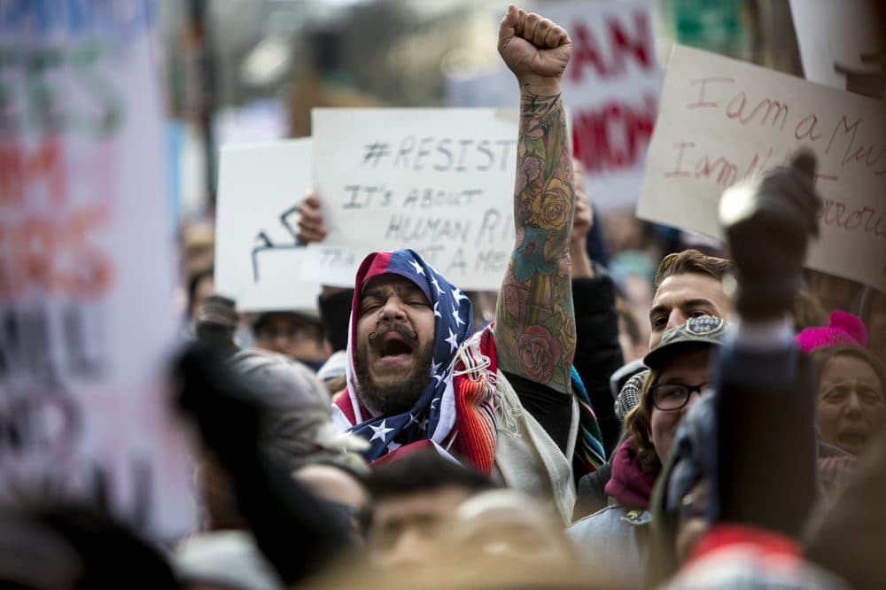 Izzy Berdan cheers during the protest at Copley Square as protesters gathered in opposition to President Trump's executive order temporarily halting immigration from seven majority-Muslim countries.(Jesse Costa/WBUR)