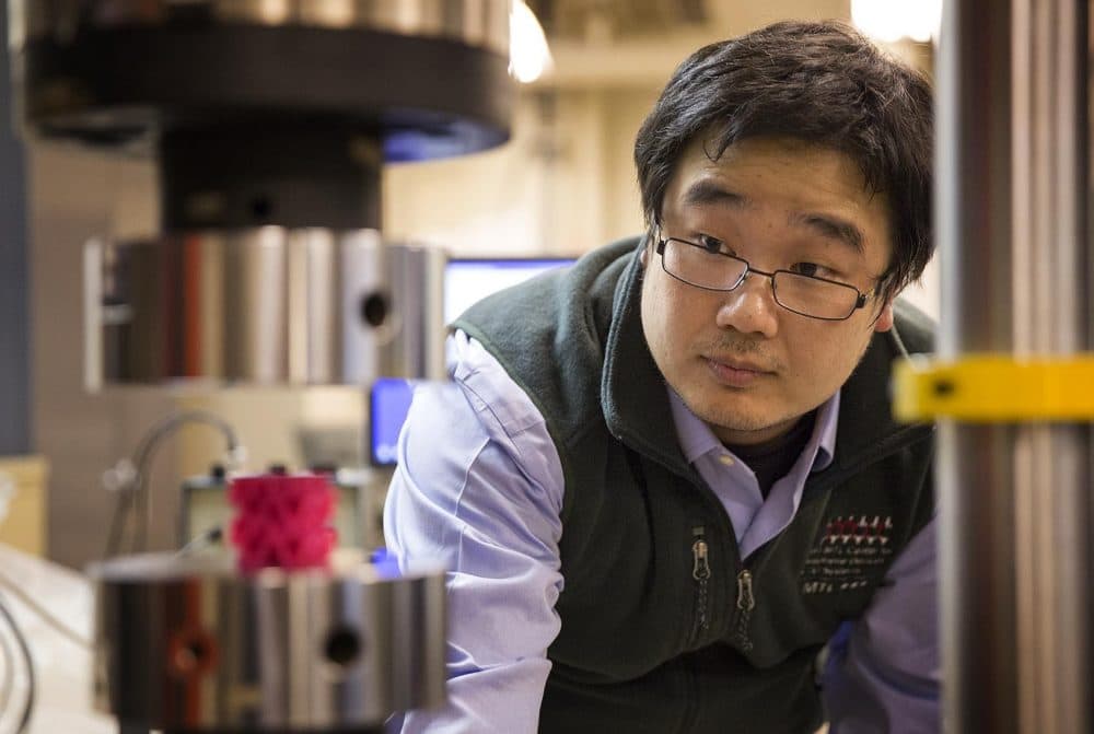 MIT research scientist Zhao Qin setting up an experiment in the lab. (Robin Lubbock/WBUR)