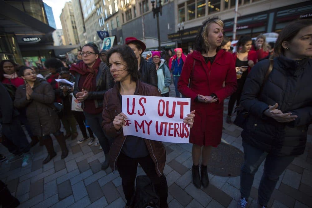 Noelle Cocoros hols a sign that reads,"U.S. out of my uterus" during the Day Without Women rally at Downtown Crossing. (Jesse Costa/WBUR)