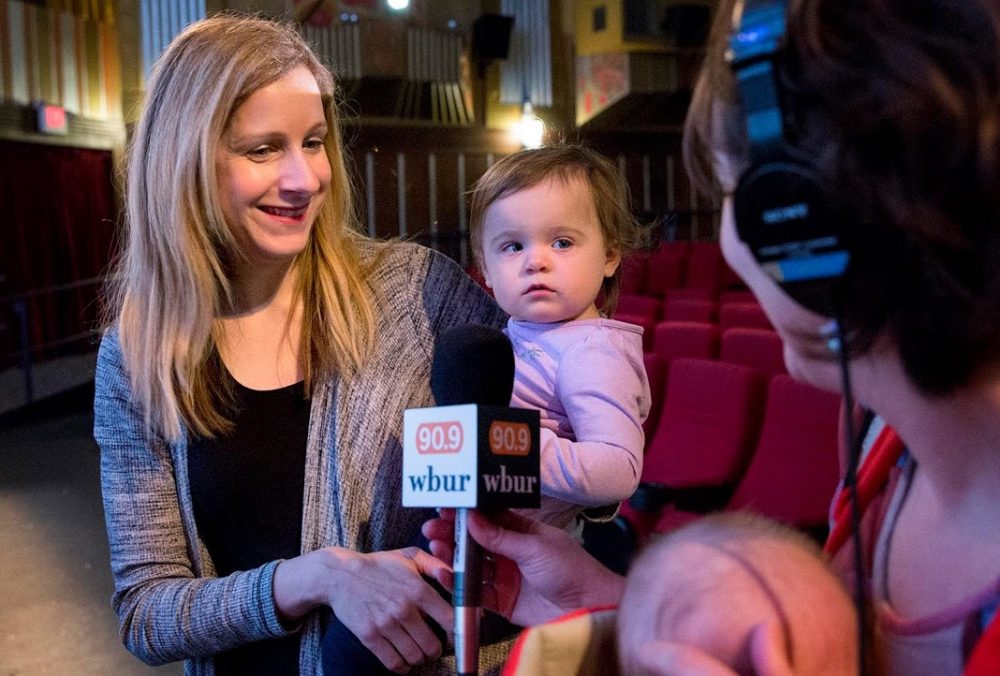 The Coolidge Corner Theatre's Beth Gilligan, and her 18-month-old daughter Laura, talk with arts reporter Erin Trahan and her 2-month-old son Zed, just before the lights go down for a screening of "Faces, Places." (Robin Lubbock/WBUR)