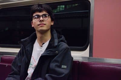 Miles Taylor, 17, rides on the Lowell commuter rail line. He's been blogging about the MBTA for five years, and has ridden more than 500 bus and train lines. (Elizabeth Gillis/WBUR)