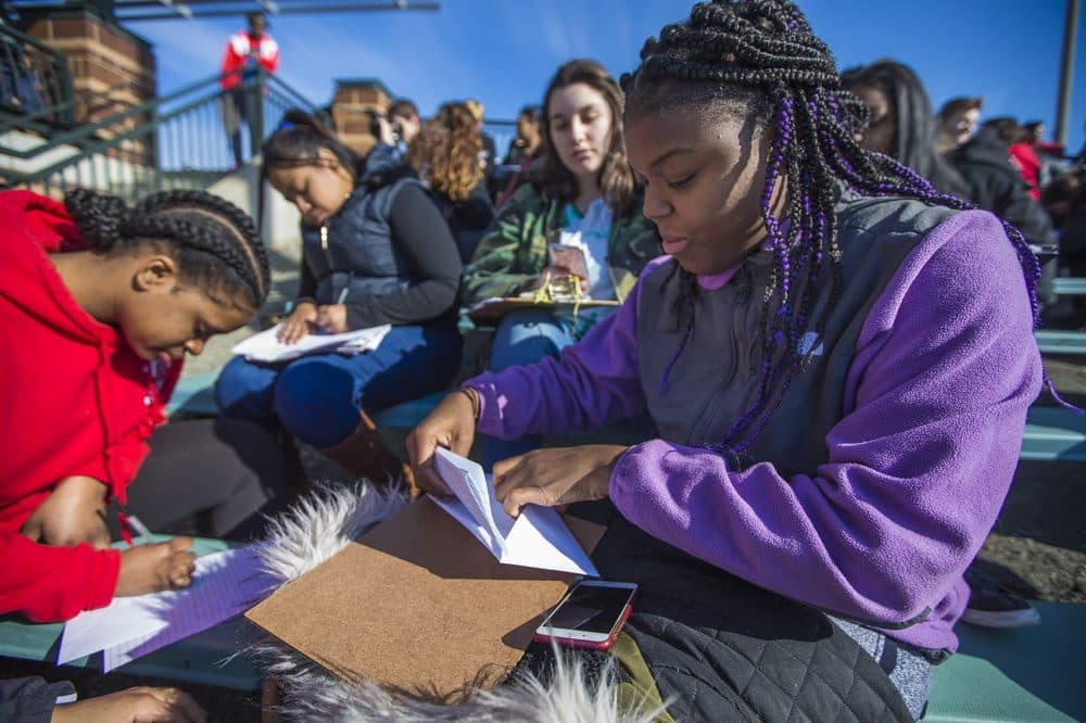 Junior Yolanda Monosiet stuffs her letter into an envelope. (Jesse Costa/WBUR)