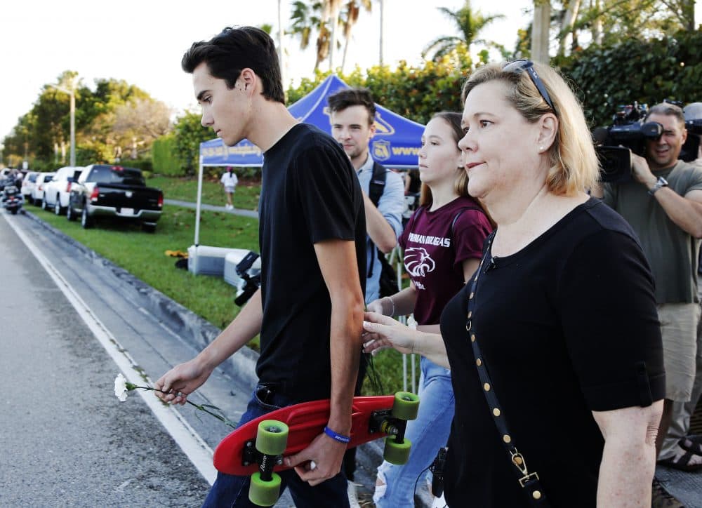 Marjory Stoneman Douglas High School student David Hogg, left, walks to class for the first time since a former student opened fire there with an assault weapon, Wednesday, Feb. 28, 2018, in Parkland, Fla. (Terry Renna/AP)