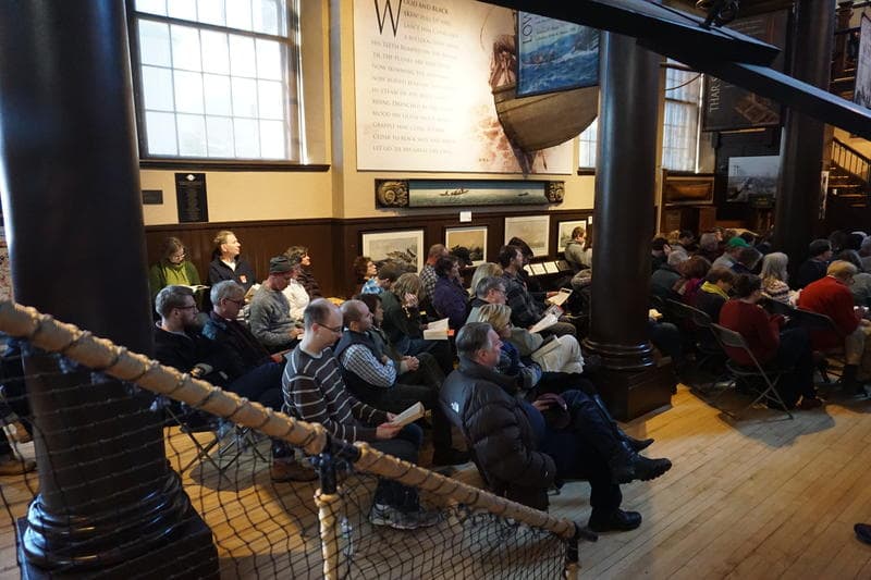 Visitors listen to Moby Dick read aloud, during the annual Moby Dick Marathon at the New Bedford Whaling Museum. (John Bender/RIPR)