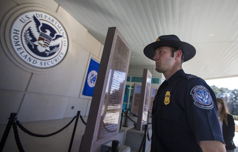 Nick Sunderhaus, CBP Field Operations Academy branch chief, walks past a memorial remembering members of Homeland Security who died in the line of duty. (Jesse Costa/WBUR)