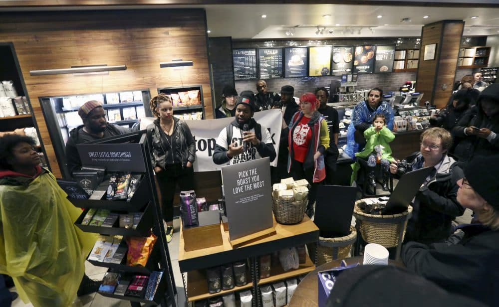 Demonstrators occupy the Starbucks that has become the center of protests Monday, April 16, 2018, in Philadelphia. Starbucks wants to add training for store managers on "unconscious bias," CEO Kevin Johnson said Monday, as activists held more protests at a Philadelphia store where two black men were arrested after employees said they were trespassing. (Jacqueline Larma/AP)