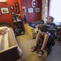 Steve Saling sits in his bedroom at the Leonard Florence Center For Living in Chelsea. (Jesse Costa/WBUR)