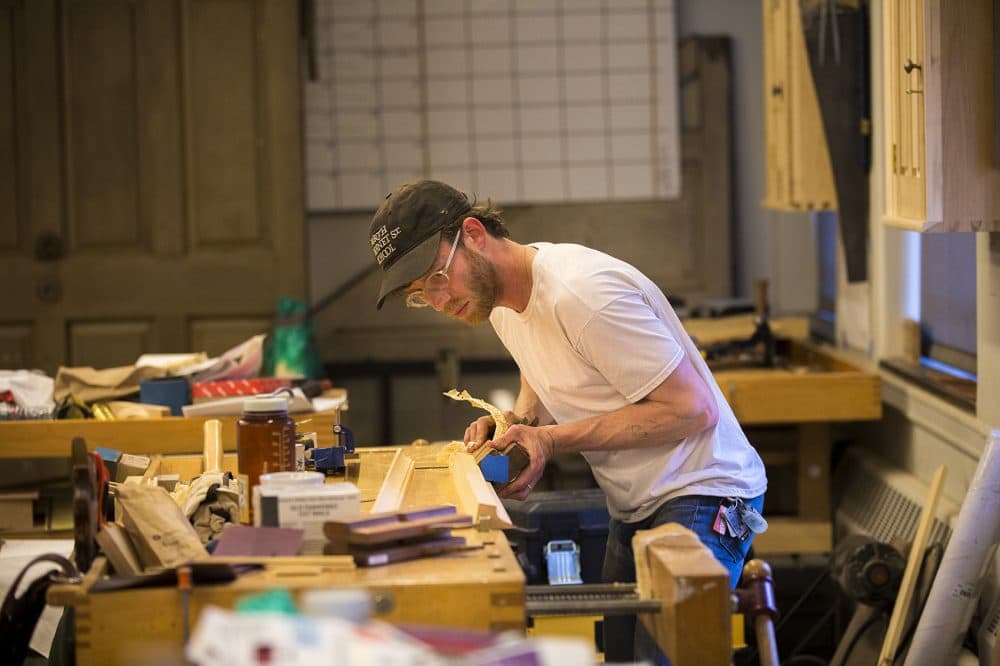 Preservation carpentry student Ian Cubie works to recreate the details of the entryway of Hancock's home. (Jesse Costa/WBUR)