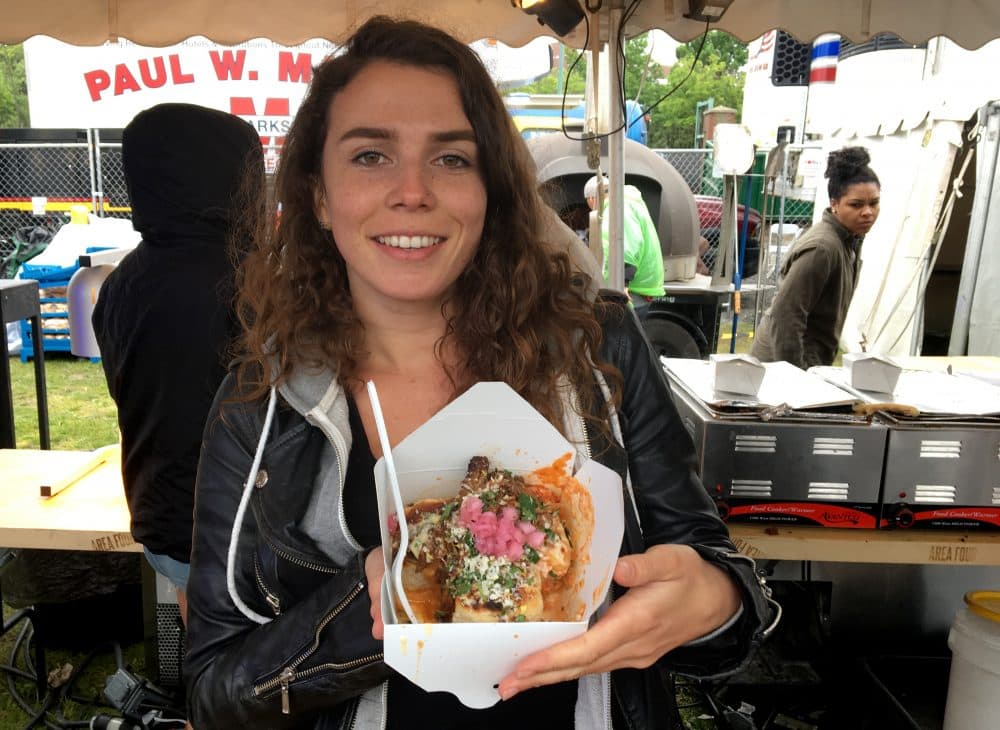 Nicole Baker holding Supreme BBQ Pork Knots from Area Four. (Andrea Shea/WBUR)