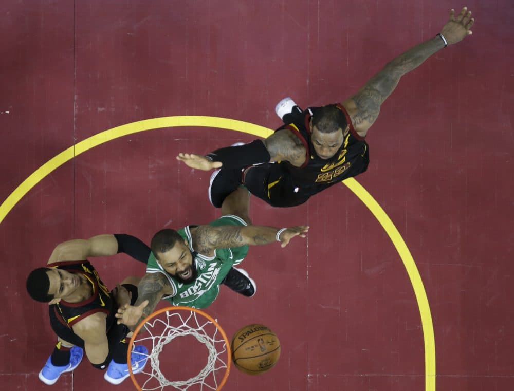 Boston Celtics' Marcus Morris goes for a rebound with Cleveland Cavaliers' Jordan Clarkson, left and Le Bron James in the first half of Game 3 of the NBA basketball Eastern Conference finals Saturday