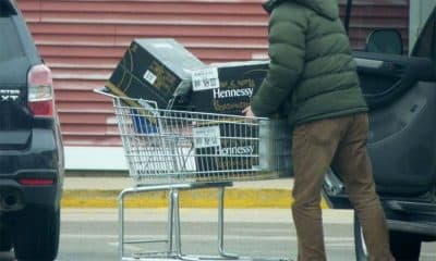 A customer loads cases of Hennessy cognac into his vehicle outside a New Hampshire liquor store in Manchester. (Todd Bookman/NHPR)