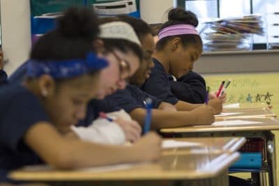 In this April 2017 photo, sixth grade students from the Boston Collegiate Charter School work on math problems during class. (Jesse Costa/WBUR)
