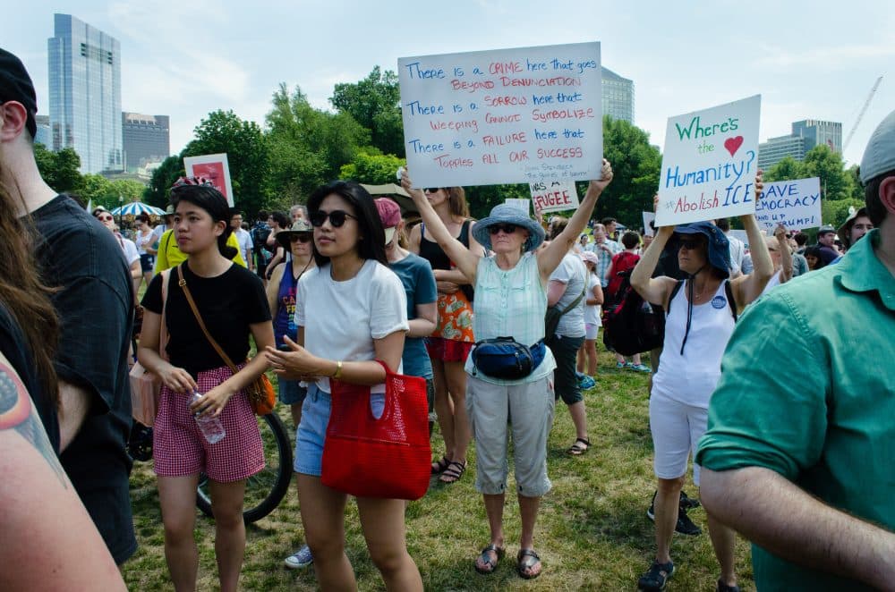"'The Grapes of Wrath' seemed particularly relevant," said Kate Hagerty, who made the sign her mother now holds above her head. (Elizabeth Gillis/WBUR)