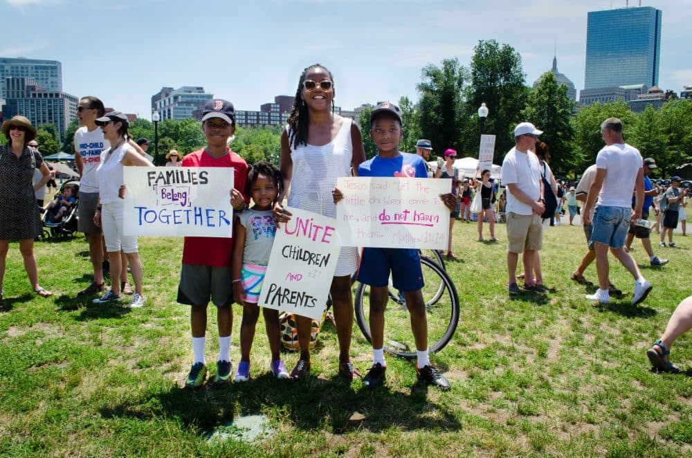 Régine Jean-Charles, from Milton, stands with her children, Bediako, Kwaku, and Farah Jean-Charles Asante. (Elizabeth Gillis/WBUR)