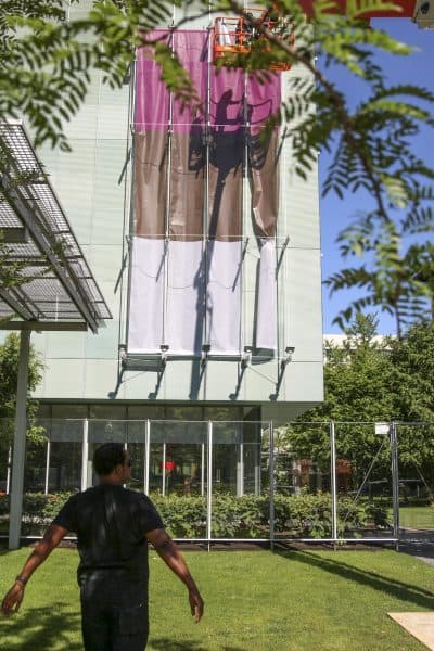 Artist Steve Locke watches the installation of his piece, "Three Deliberate Grays for Freddie." (Courtesy Isabella Stewart Gardner Museum)
