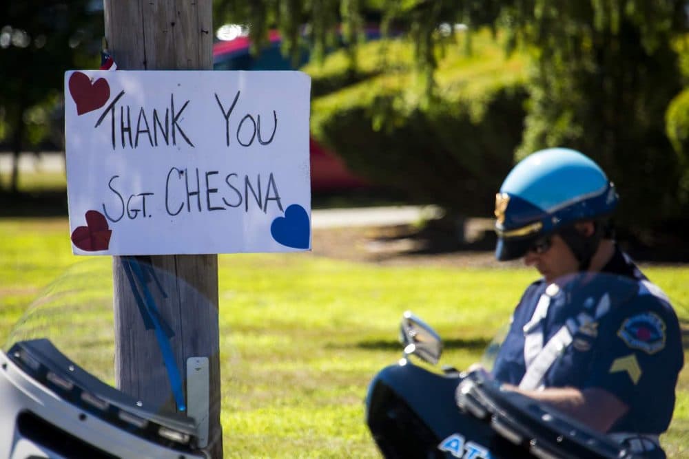 A sign reading "Thank you Sgt. Chesna" hung on a utility pole outside of Saint Mary of the Sacred Heart Church in Hanover. (Jesse Costa/WBUR)