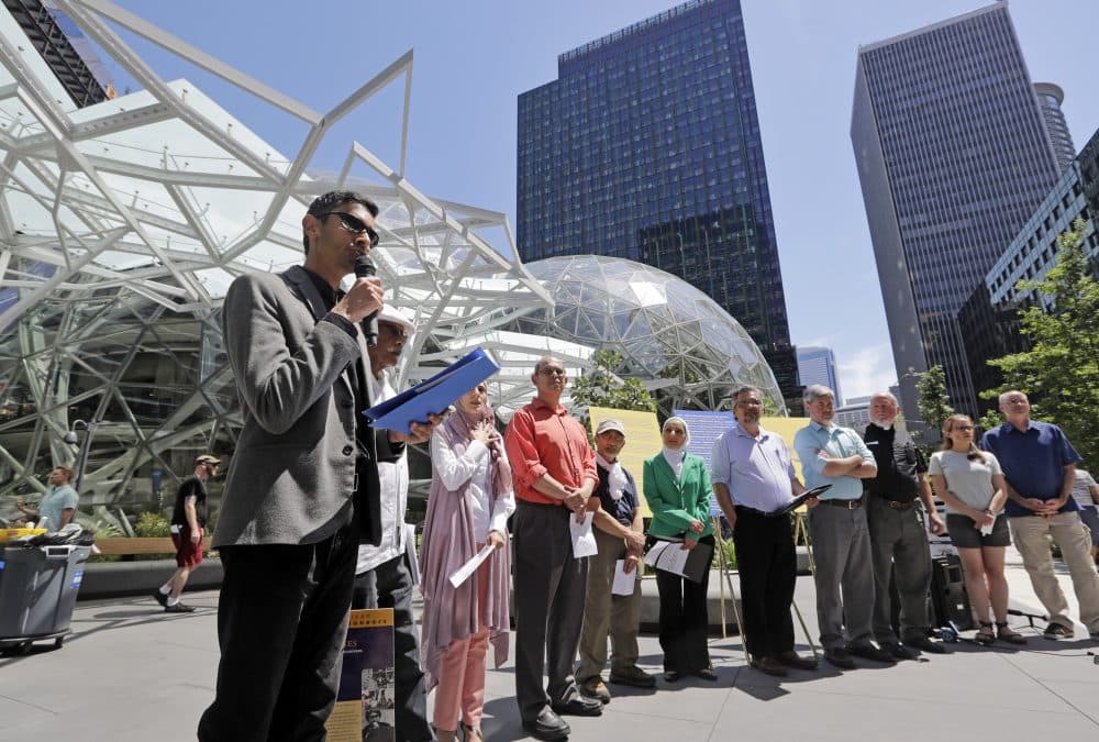 Shankar Narayan, legislative director of the ACLU of Washington, left, speaks at a June 18 news conference outside Amazon headquarters in Seattle. Community-based organizations urged Amazon to stop selling its face surveillance system, Rekognition, to the government. (Elaine Thompson/AP)