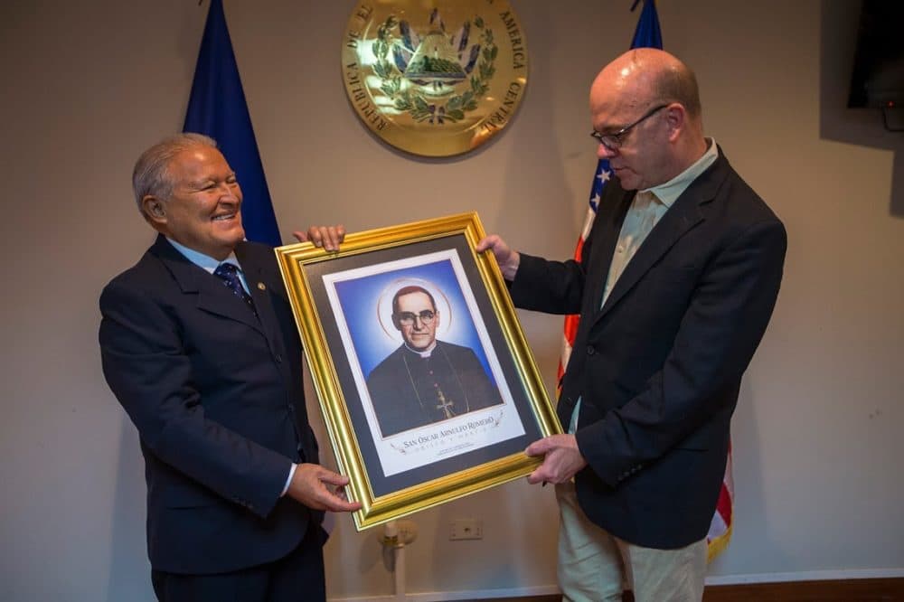 El Salvador President Salvador Sánchez Cerén gives Congressman Jim McGovern a gift, a portrait of Monsignor Oscar Romero at the Casa Presidencial in San Salvador. McGovern has long admired Romero for his work against poverty, social injustice, assassinations and torture. (Jesse Costa/WBUR)