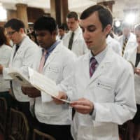 Thomas Jefferson University's Jefferson Medical College first-year student William E. Wieczorek and others take the Hippocratic Oath during the annual White Coat Ceremony, Friday, Aug. 5, 2011, in Philadelphia. The ceremony symbolizes the clinical beginning of the students' medical educations. (Matt Rourke/AP)