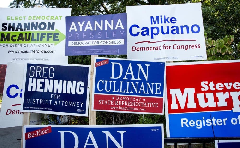 Campaign boards outside the Adams Street Library in Dorchester. (Robin Lubbock/WBUR)