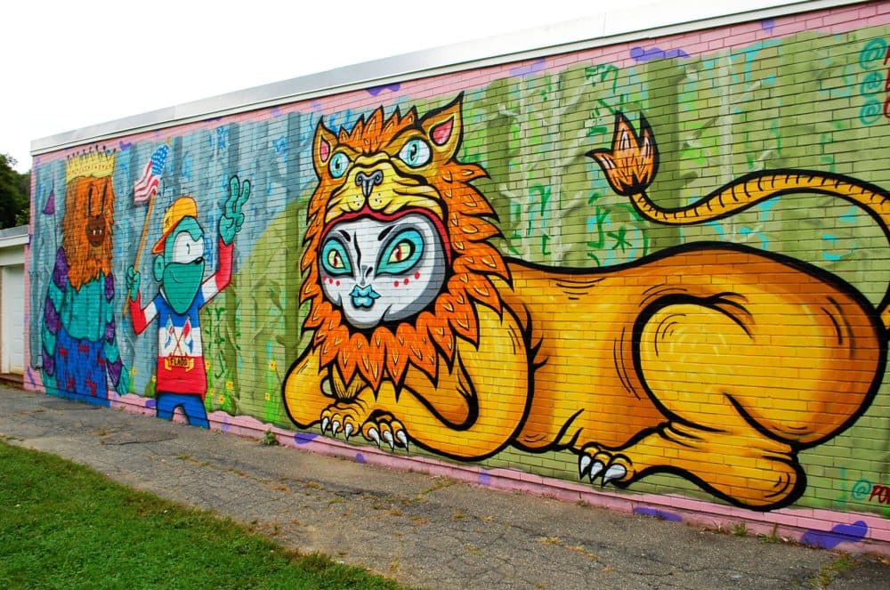 Grace Lang, Ramiro Davaro-Comas and BelowKey's mural in Worcester. (Dana Forsythe for WBUR)