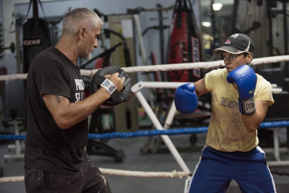 Carolin Camacho Flores, right, trains with Ruben Flores at the La Mesa Fitness Center in Caguas. (Jesse Costa/WBUR)