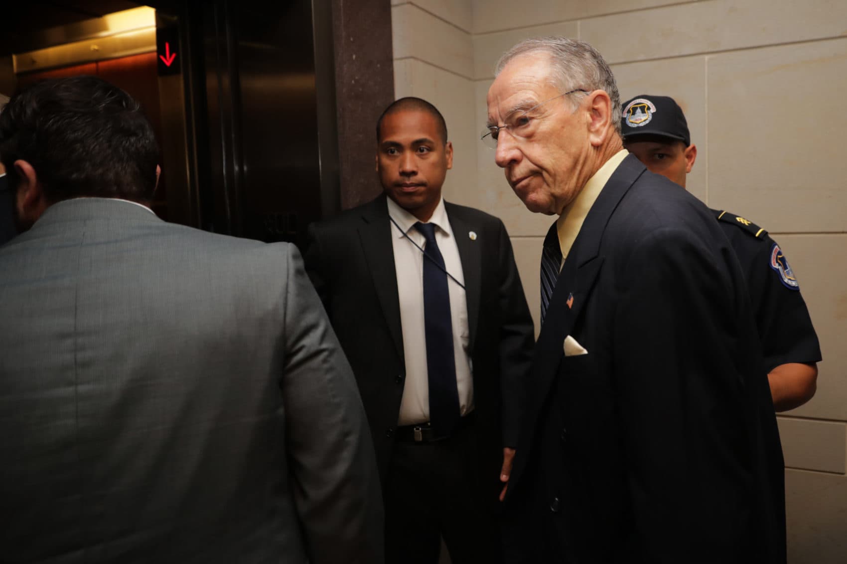 Senate Judiciary Committee Chairman Charles Grassley (R-IA) is surrounded by staff and security as he heads for a secure meeting space inside the U.S. Capitol Visitors Center to review the FBI report about alleged sexual misconduct by Supreme Court nominee Judge Brett Kavanaugh on Thursday in Washington, D.C. (Photo by Chip Somodevilla/Getty Images)