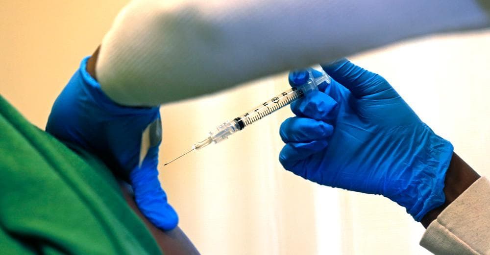 Registered nurse Charlene Luxcin administers a flu shot to a patient at the Whittier Street Health Center in Boston, on Wednesday, Jan. 9, 2013. (Charles Krupa/AP)
