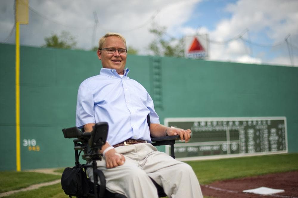 Travis Roy, the namesake of the Travis Roy Foundation, sits by third base at "Little Fenway", which is modeled after Boston's Fenway Park, before a charity Wiffle Ball tournament to benefit the Foundation in Essex, Vt., on Friday, August 12, 2011. (Andy Duback/AP)