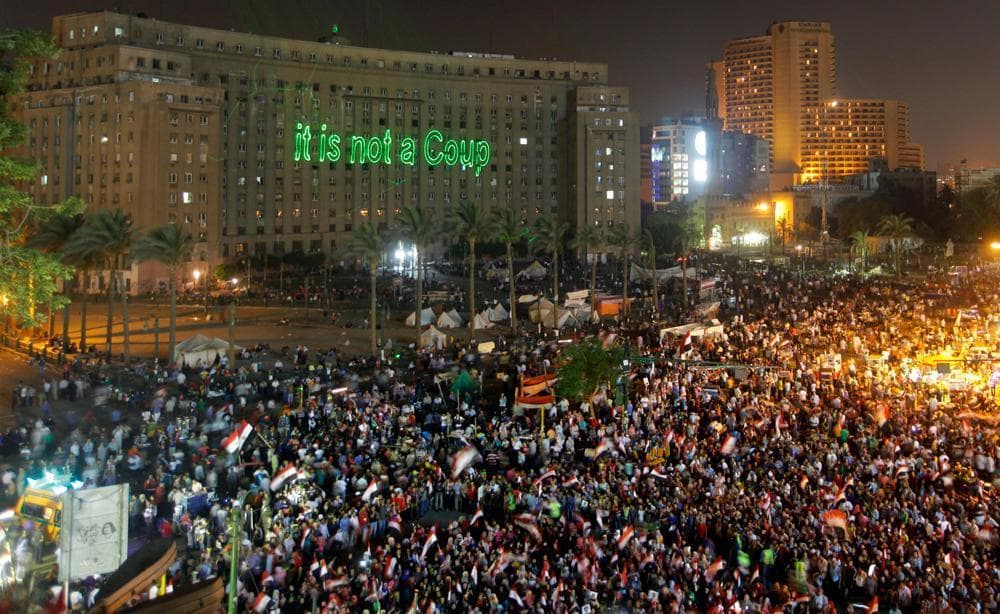 Opponents of Egypt's Islamist ousted president Mohammed Morsi wave national flags as they celebrate in Tahrir Square, in Cairo, Egypt, Friday, July 5, 2013. (Amr Nabil/AP)