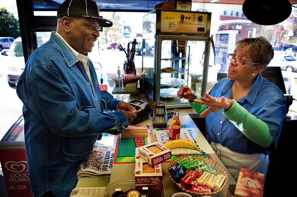 Stacey Thomas, right, works seven days a week at the family’s Mobil Station on Blue Hill Avenue in Mattapan Square. (Jesse Costa/WBUR)