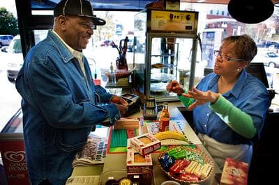 Stacey Thomas, right, works seven days a week at the family’s Mobil Station on Blue Hill Avenue in Mattapan Square. (Jesse Costa/WBUR)