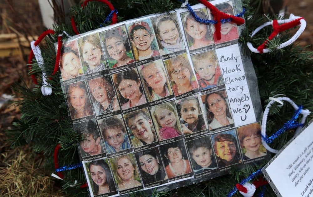 Photos of Sandy Hook Elementary School massacre victims sit at a small memorial near the school on January 14, 2013, in Newtown, Connecticut. (John Moore/Getty Images)