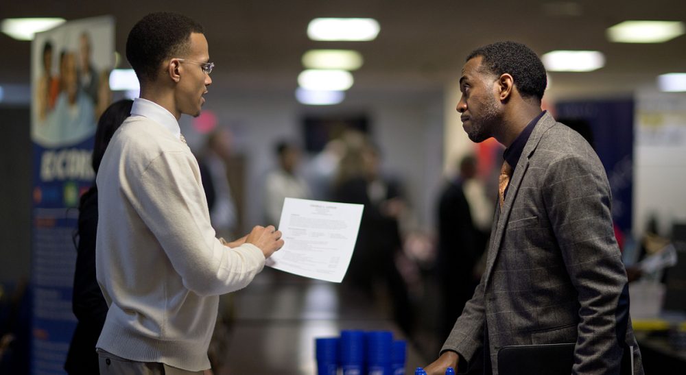 Retired U.S. Air Force Master Sgt. Thomas Gipson, of Atlanta, right, has his resume looked over by Ralph Brown, a management and program analyst with the Centers for Disease Control and Prevention, during a job fair, Thursday, Nov. 14, 2013, in Marietta, Ga. (David Goldman/ AP)