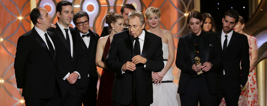 Charles Roven, center, accepts the award for best motion picture comedy for "American Hustle." (Paul Drinkwater/NBC/AP)