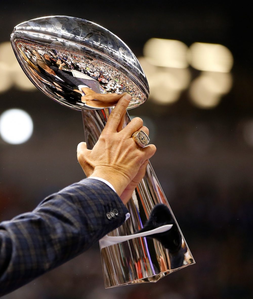 The Vince Lombardi Championship trophy is held by Baltimore Ravens team owner Steve Bisciotti after the Ravens won the Super Bowl in 2013. (Chris Graythen/Getty Images)
