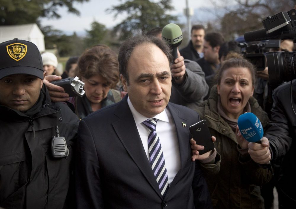 Monzer Akbik, center, a spokesman of the of the Syrian National Coalition, Syria's main political opposition group, is surrounded by journalists after a meeting with the Syrian government at the United Nations headquarters in Geneva, Switzerland. (Anja Niedringhaus/AP)