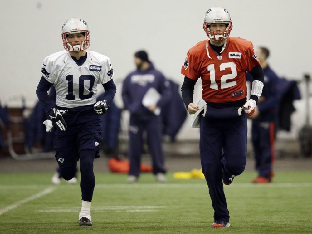 New England Patriots quarterback Tom Brady (12) and wide receiver Austin Collie (10) run during a stretching session before NFL football practice at the team's facility in Foxborough, Mass., Tuesday, Jan. 7, 2014. The Patriots are scheduled to host the Indianapolis Colts in an NFL football divisional playoff game on Saturday, Jan. 11. (AP)