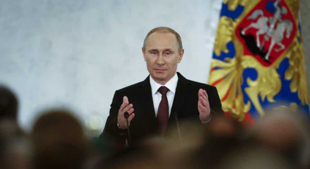 Russian President Vladimir Putin gestures as he arrives to address the Federal Assembly in the Kremlin in Moscow, Tuesday, March 18, 2014. (Alexander Zemlianichenko/AP)