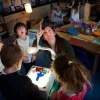 Using a projector, Jodi Doyle points out shadows on the ceiling to students of her preschool class at the Eliot K-to-8 Innovation School in Boston's North End. (Jesse Costa/WBUR)