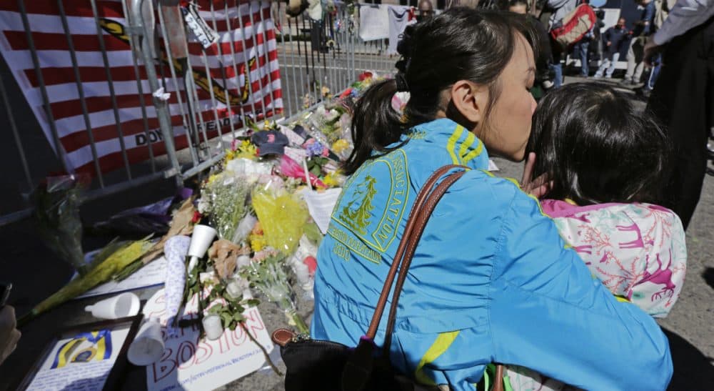 Sharon Brody: Worrying is folly. It represents a flailing effort to gain, or to pretend to gain, some power over the unpredictable comings and goings of life. In this photo, Boston Marathon runner Vu Trang, of San Francisco, kisses her two-year-old daughter Cara at a makeshift memorial on Boylston Street, April 17, 2013. (Charles Krupa/AP)