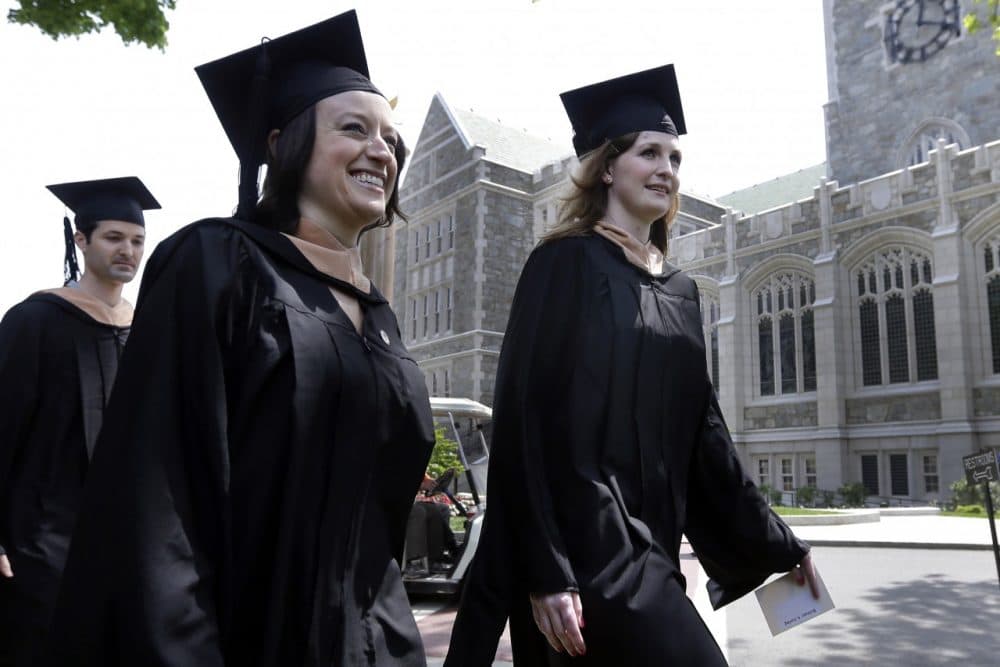 Liza Cherney, left, and Brittany Loring, right, lead the procession of graduates of the Carroll School of Management during commencement ceremonies at Boston College May 20, 2013. (Elise Amendola/AP)
