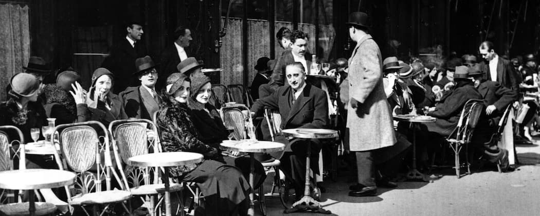 Patrons enjoy the sun outside Weber's Cafe at Rue Royale, around Eastertide in Paris, April 6, 1932. (AP)